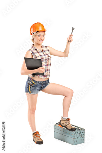 Photo: Female mechanic holding a wrench Female mechanic holding a wrench