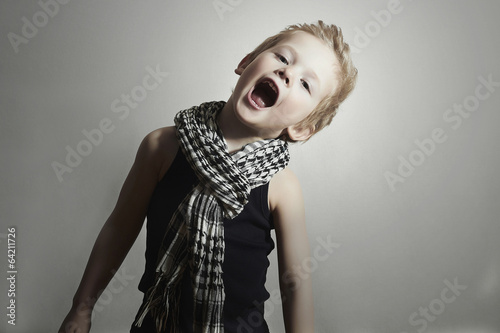 Photo: fashionable little boy in scarf.fashion children.Funny Child fashionable little boy in scarf.fashion children.Funny Child