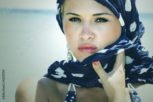 Photo: beautiful woman on the beach.Arabian style.Summer.freckles beautiful woman on the beach.Arabian style.Summer.freckles