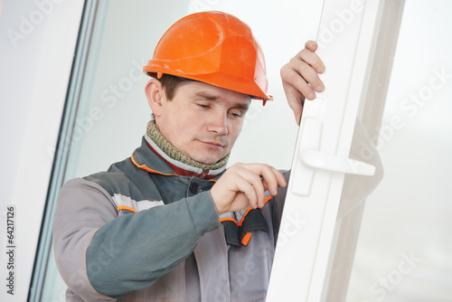 Photo: Male carpenter at lock installation Male carpenter at lock installation