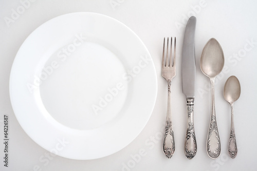 Photo: Vintage cutlery set with fork, knife, spoon and plate Vintage cutlery set with fork, knife, spoon and plate