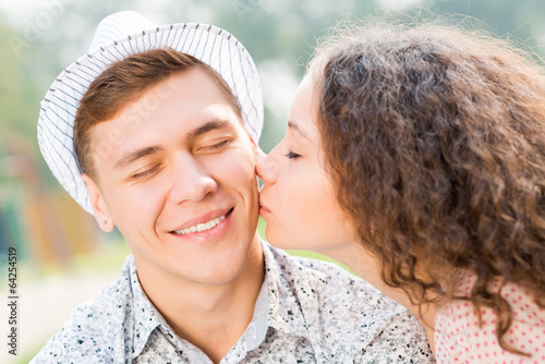 Photo: girl kissing a man on the cheek girl kissing a man on the cheek
