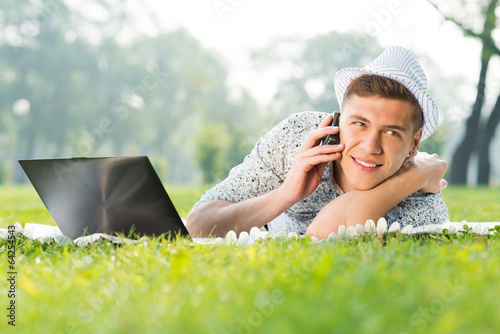 Photo: young man with a cell phone young man with a cell phone