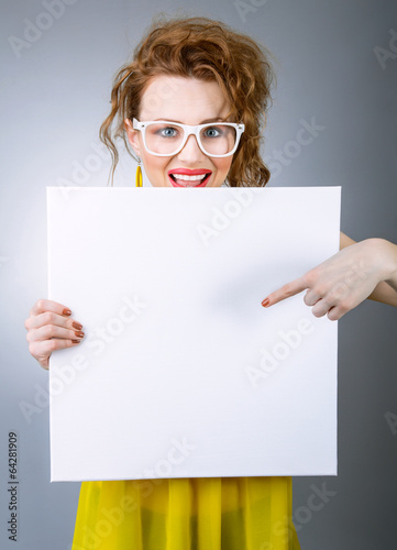 Photo: Surprised woman holding white board Surprised woman holding white board