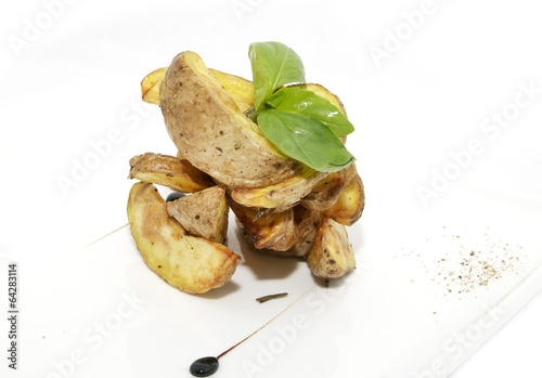 Photo: Baked potatoes on a plate decorated with greens Baked potatoes on a plate decorated with greens