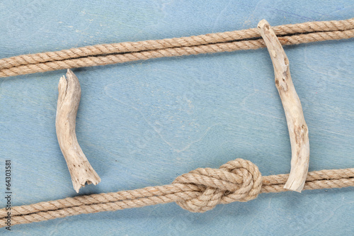 Photo: Ship rope on old wooden texture background Ship rope on old wooden texture background