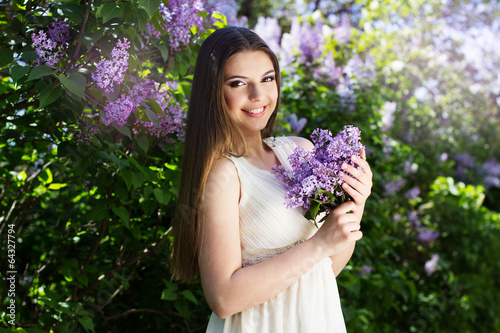 Photo: Beautiful girl with a lilac flowers Beautiful girl with a lilac flowers