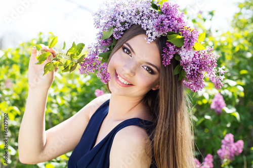 Photo: Beautiful girl with a lilac flowers Beautiful girl with a lilac flowers