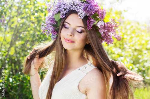 Photo: Beautiful girl with a lilac flowers Beautiful girl with a lilac flowers