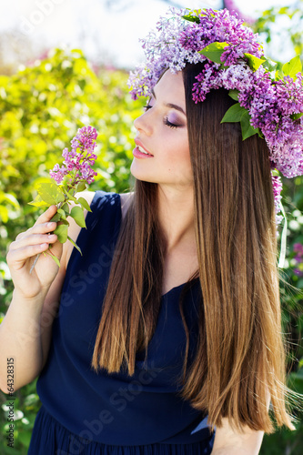 Photo: Beautiful girl with a lilac flowers Beautiful girl with a lilac flowers