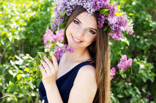 Photo: Beautiful girl with a lilac flowers Beautiful girl with a lilac flowers