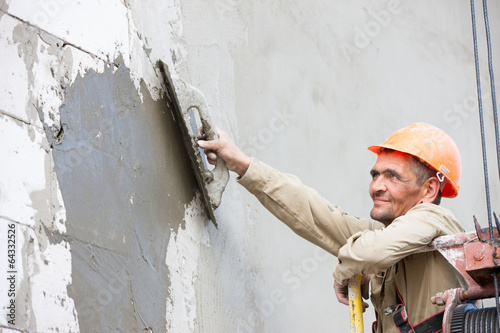 Photo: Plastering multi storey building wall of concrete blocks Plastering multi storey building wall of concrete blocks