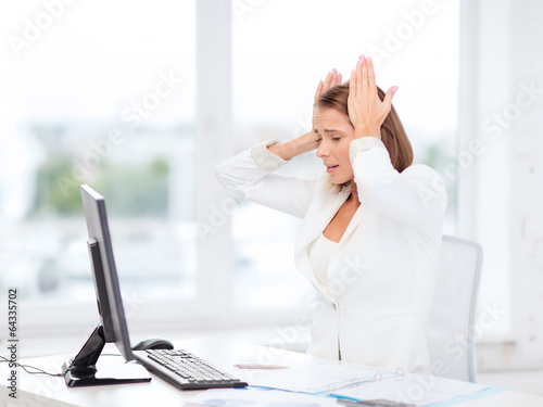 Photo: stressed businesswoman with computer at work stressed businesswoman with computer at work