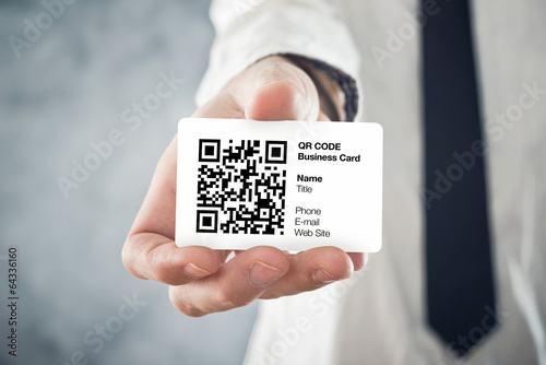 Photo: Businessman holding QR code business card Businessman holding QR code business card