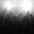 People in front of stage with bright lights People in front of stage with bright lights