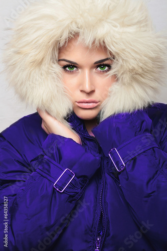 Photo: beautiful woman with fur hood.winter.fashion girl in blue coat beautiful woman with fur hood.winter.fashion girl in blue coat