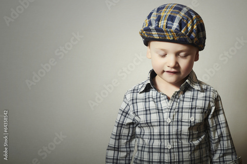 Photo: Child. Fashionable Little Boy in Cap. Fashion Children Child. Fashionable Little Boy in Cap. Fashion Children