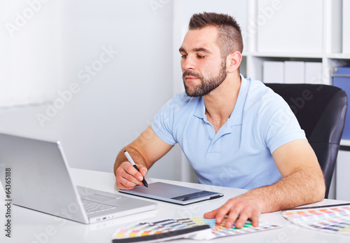 Photo: Graphic designer working on digital tablet Graphic designer working on digital tablet