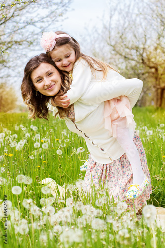 Photo: Mother and daughter in field with dandelions Mother and daughter in field with dandelions