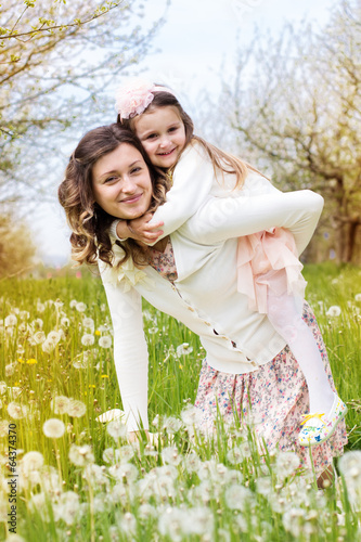 Photo: Mother and daughter in field with dandelions Mother and daughter in field with dandelions