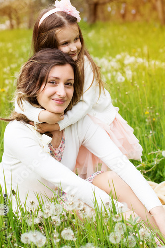 Photo: Mother and daughter in field with dandelions Mother and daughter in field with dandelions
