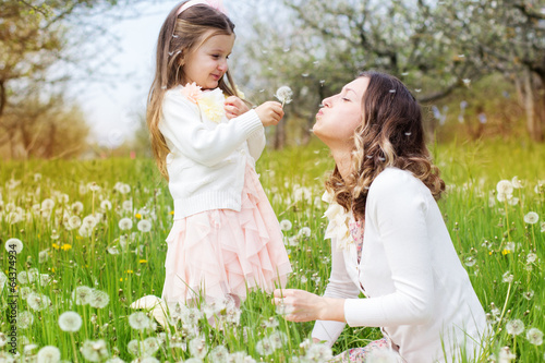 Photo: Mother and daughter in field with dandelions Mother and daughter in field with dandelions
