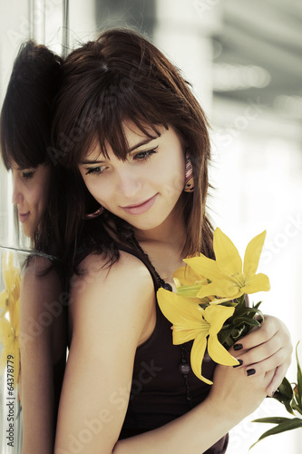 Photo: Happy young woman with a flowers Happy young woman with a flowers