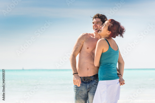 Photo: Young Couple Walking on Caribbean Beach Young Couple Walking on Caribbean Beach