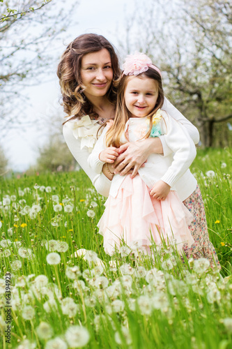 Photo: Mother and daughter in field with dandelions Mother and daughter in field with dandelions