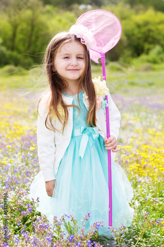 Photo: Little girl on the nature with butterfly net Little girl on the nature with butterfly net