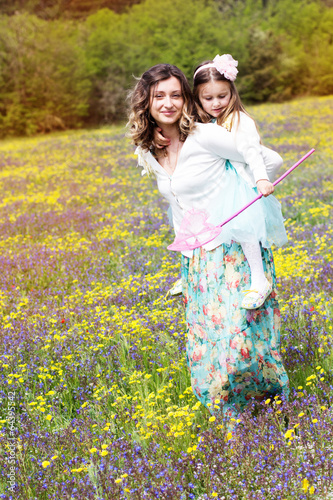 Photo: Mother and daughter in field with colorful flowers Mother and daughter in field with colorful flowers