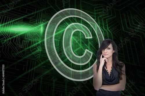 Photo: Composite image of copyright symbol and sexy brunette Composite image of copyright symbol and sexy brunette