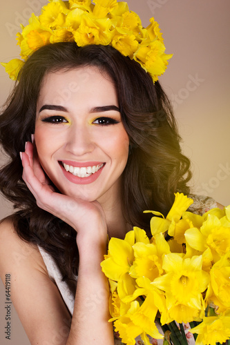 Photo: Happy smiling girl with yellow flowers Happy smiling girl with yellow flowers
