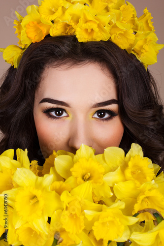Photo: Happy smiling girl with yellow flowers Happy smiling girl with yellow flowers