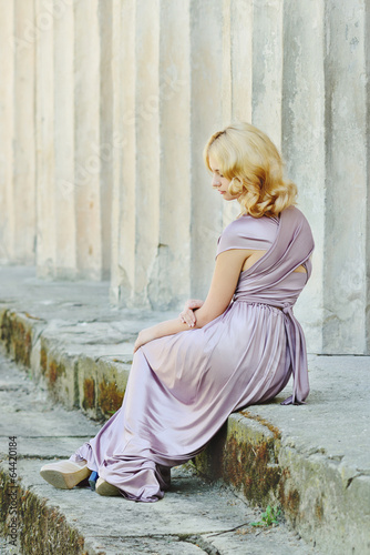 Photo: model sitting near old columns model sitting near old columns