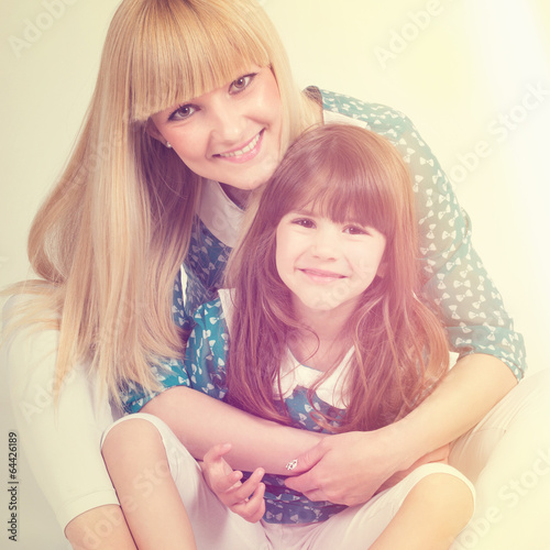 Photo: Happy mom and daughter hugging and smiling Happy mom and daughter hugging and smiling