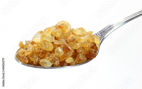 Photo: Cane sugar on spoon Cane sugar on spoon