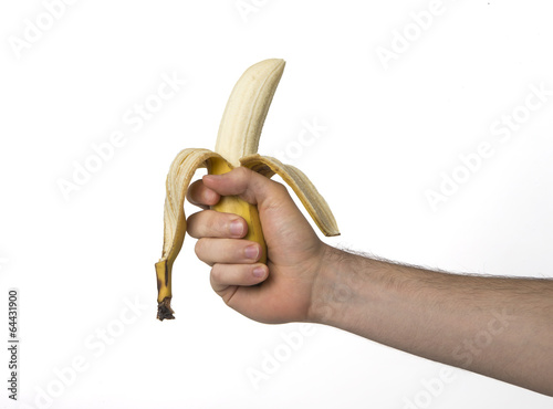 Photo: Hand holding a banana on white background, contoured Hand holding a banana on white background, contoured