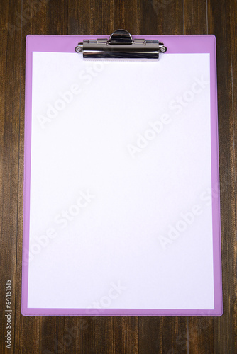 Photo: Clipboard on wooden background Clipboard on wooden background