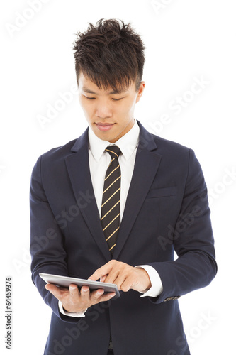 Photo: young businessman holding a tablet and touching screen young businessman holding a tablet and touching screen