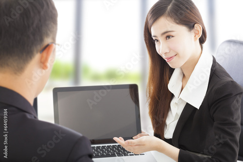 Photo: smiling Business woman presenting and explaining a project smiling Business woman presenting and explaining a project