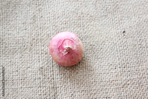 Photo: vegetable of shallots or red onion on sackcloth. vegetable of shallots or red onion on sackcloth.