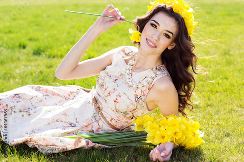 Photo: Happy smiling girl with yellow flowers Happy smiling girl with yellow flowers