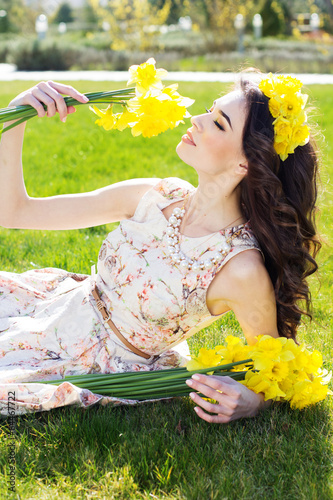 Photo: Happy smiling girl with yellow flowers Happy smiling girl with yellow flowers