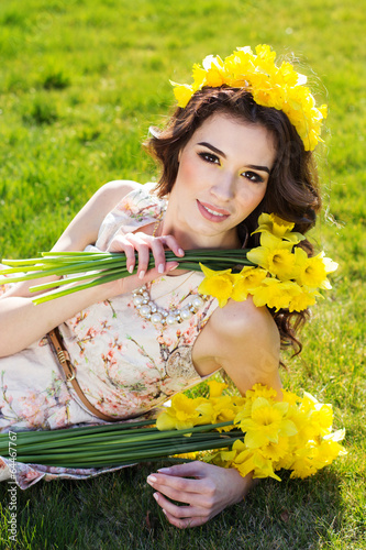 Photo: Happy smiling girl with yellow flowers Happy smiling girl with yellow flowers