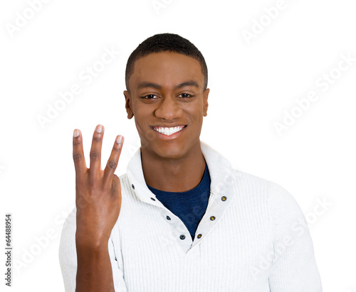 Photo: Portrait handsome young man giving three gesture sign Portrait handsome young man giving three gesture sign