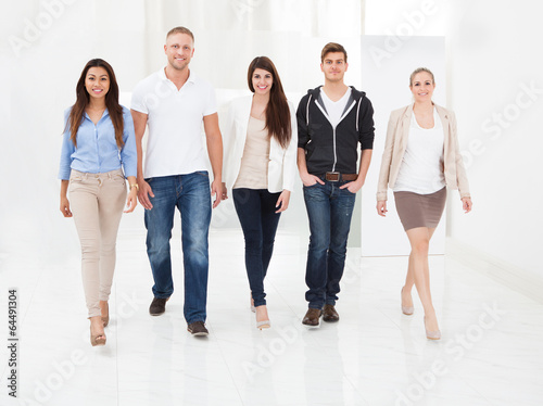 Photo: Confident Businesspeople Walking Together Confident Businesspeople Walking Together