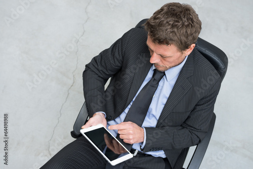 Photo: Businessman working with tablet Businessman working with tablet
