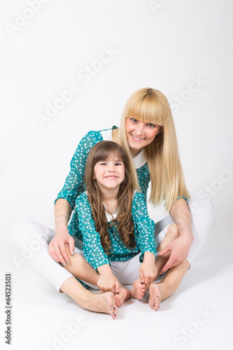 Photo: Mother and daughter hug sitting wearing matching outfit Mother and daughter hug sitting wearing matching outfit