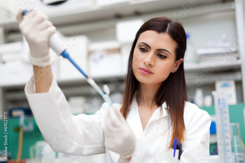 Photo: Female scientist doing a test in a laboratory Female scientist doing a test in a laboratory